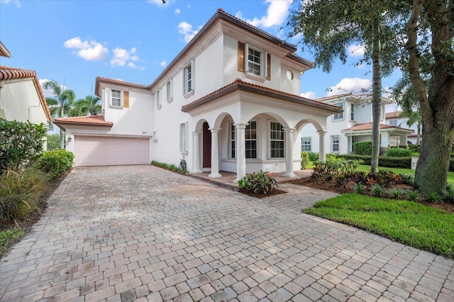 mediterranean / spanish-style home with a garage