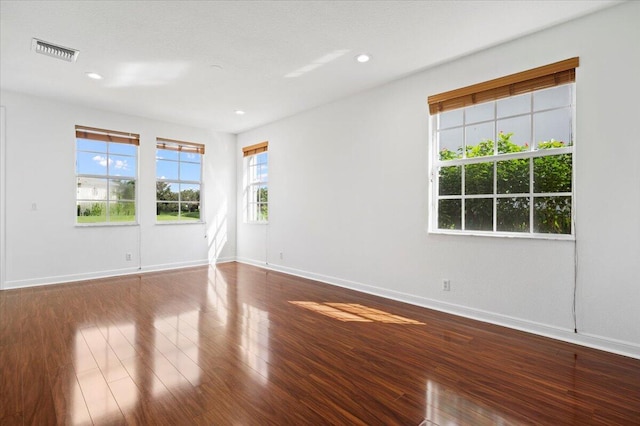 empty room with hardwood / wood-style flooring