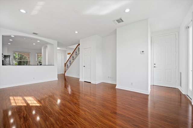 unfurnished living room featuring dark hardwood / wood-style flooring