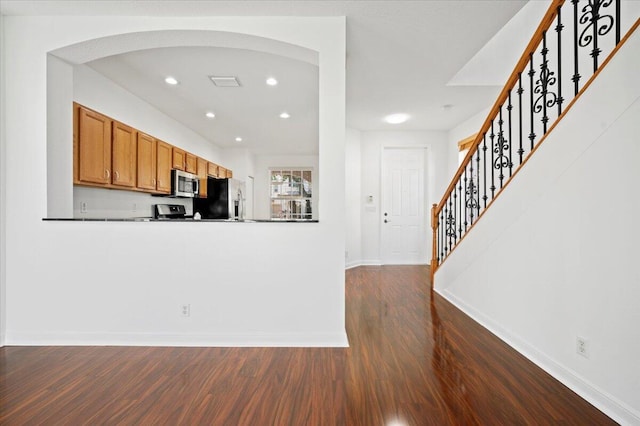 kitchen with stainless steel appliances and dark hardwood / wood-style flooring