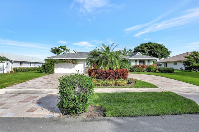 ranch-style house featuring a front yard and a garage