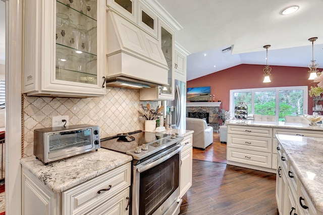 kitchen with electric range, light stone countertops, dark wood-type flooring, lofted ceiling, and decorative light fixtures