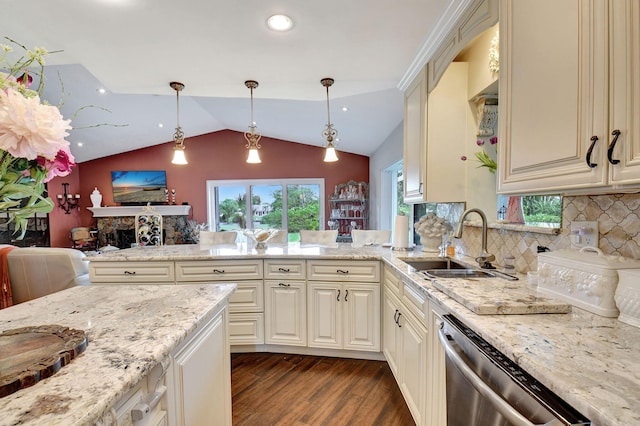 kitchen with sink, cream cabinets, hanging light fixtures, dark wood-type flooring, and backsplash