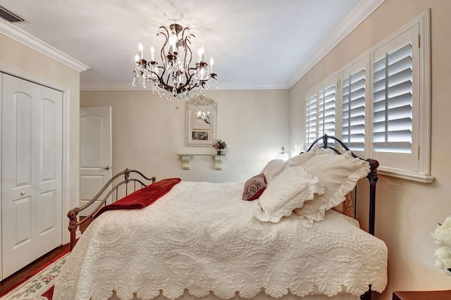 bedroom featuring wood-type flooring, an inviting chandelier, a closet, and ornamental molding