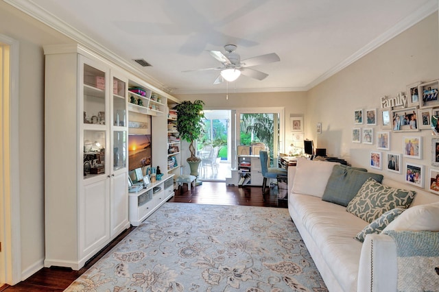 living room with wood-type flooring, ceiling fan, and crown molding