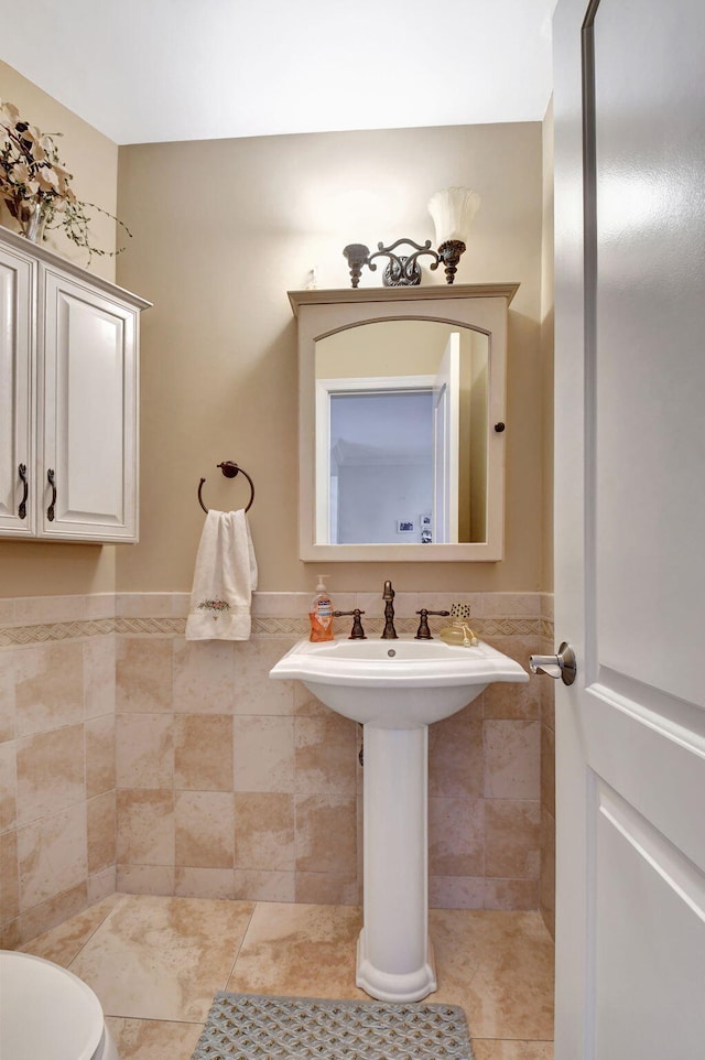 bathroom featuring tile patterned floors, tile walls, and toilet