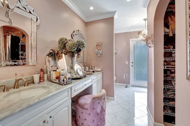 bathroom featuring vanity, ornamental molding, and toilet