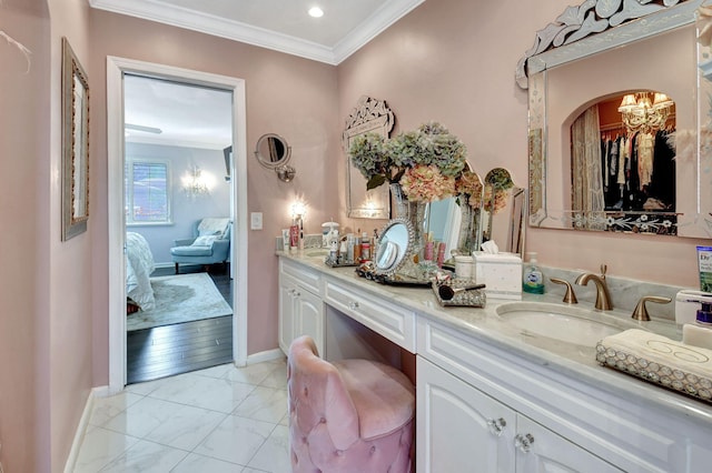 bathroom featuring crown molding, hardwood / wood-style floors, vanity, and a notable chandelier