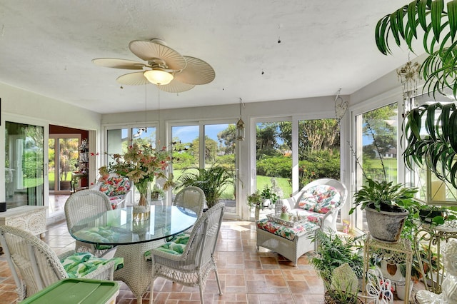 sunroom featuring ceiling fan and a healthy amount of sunlight