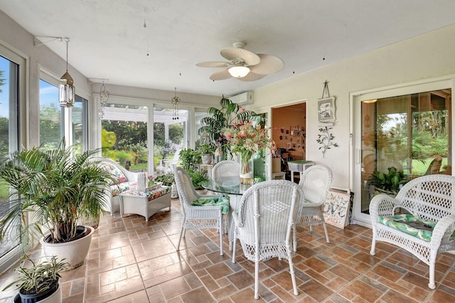 sunroom with ceiling fan and a wall unit AC