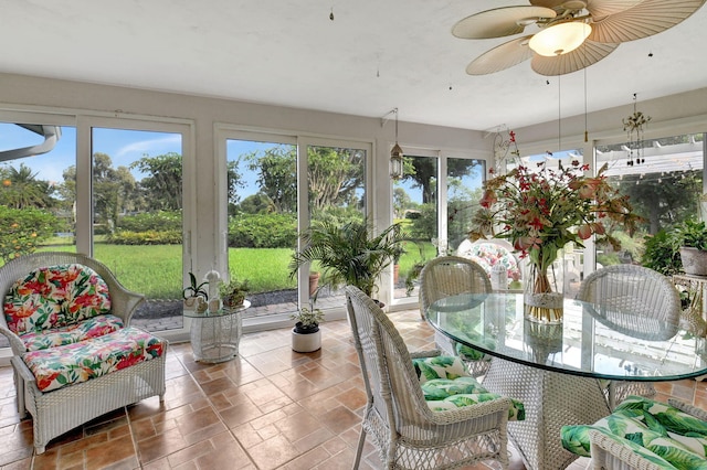 sunroom / solarium featuring ceiling fan