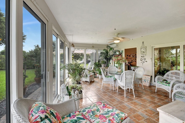 sunroom / solarium featuring ceiling fan