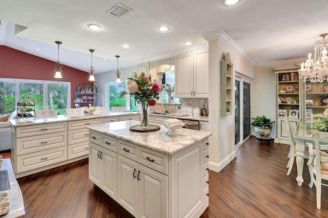 kitchen featuring kitchen peninsula, a kitchen island, pendant lighting, and dark hardwood / wood-style floors