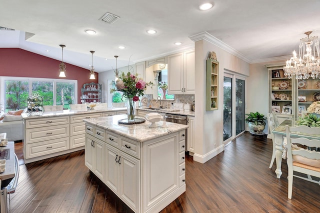 kitchen with white cabinetry, sink, dark wood-type flooring, pendant lighting, and a kitchen island