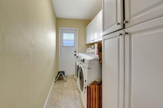 clothes washing area with cabinets, independent washer and dryer, and light tile patterned flooring