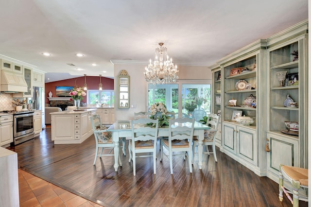 dining area featuring dark hardwood / wood-style flooring, ornamental molding, and a notable chandelier