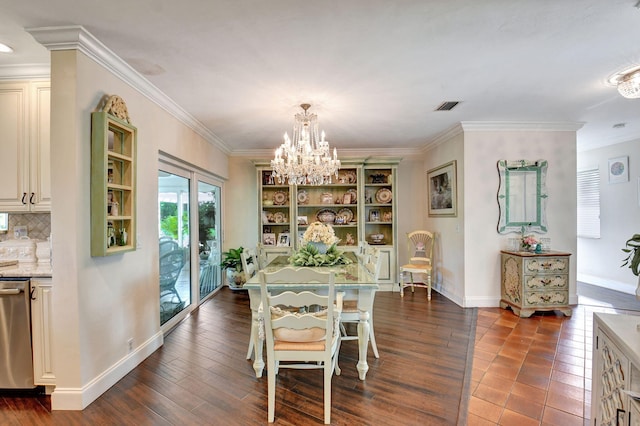 dining room featuring a chandelier, ornamental molding, and dark wood-type flooring