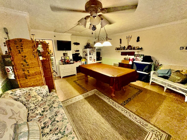 rec room featuring a textured ceiling, ceiling fan, crown molding, and billiards