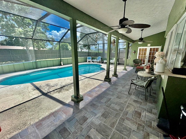 view of pool featuring ceiling fan, french doors, a lanai, an outdoor living space, and a patio