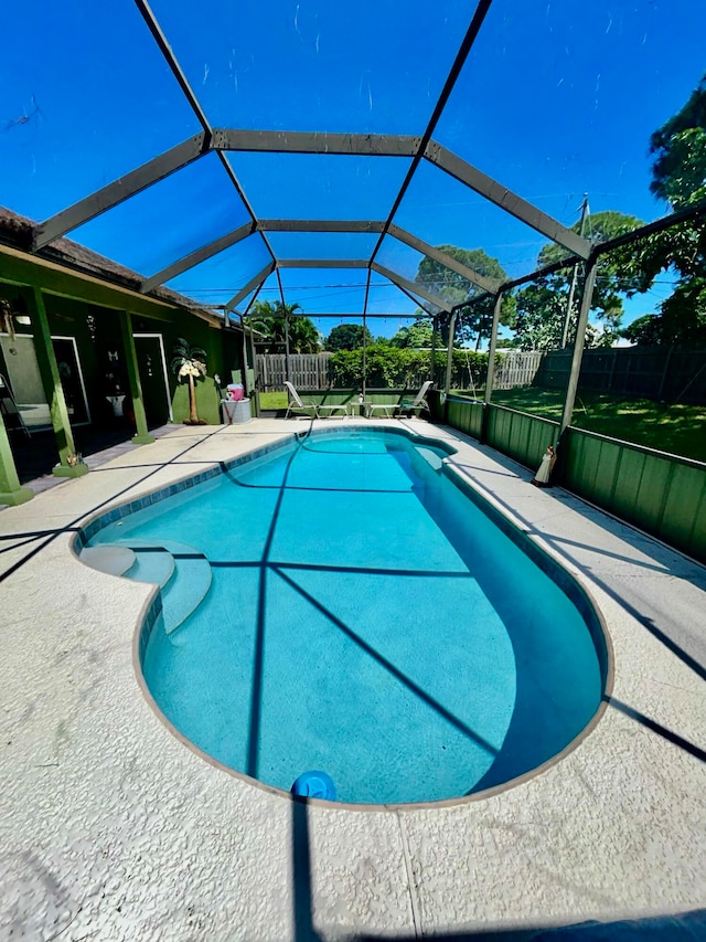 view of pool with a lanai and a patio area