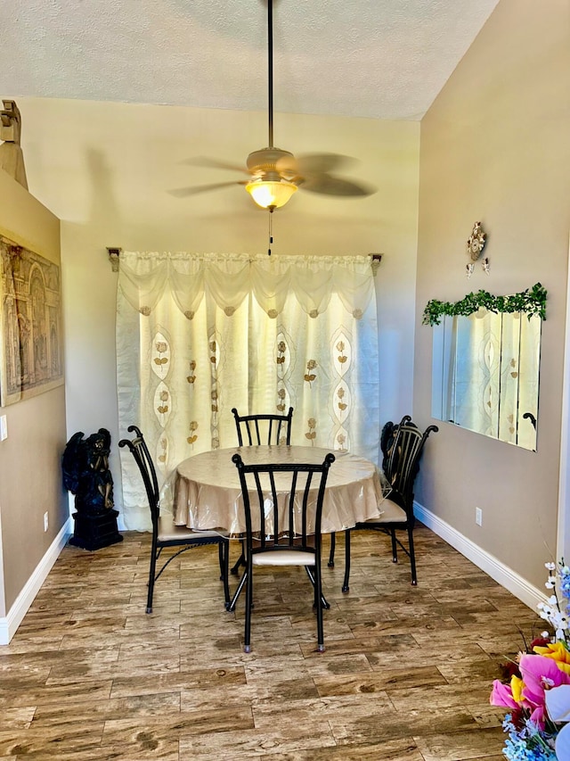 dining room featuring ceiling fan, wood-type flooring, and a textured ceiling