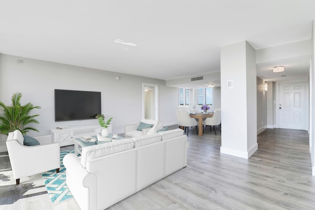 living room with light hardwood / wood-style flooring