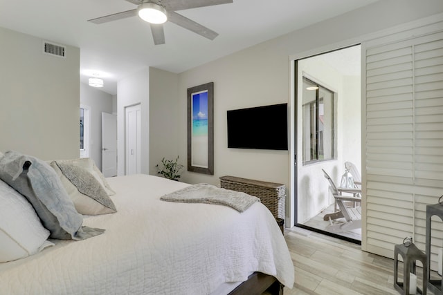 bedroom with light hardwood / wood-style floors, a closet, and ceiling fan