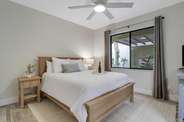 bedroom featuring light hardwood / wood-style flooring and ceiling fan