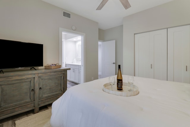 bedroom with a closet, connected bathroom, and ceiling fan