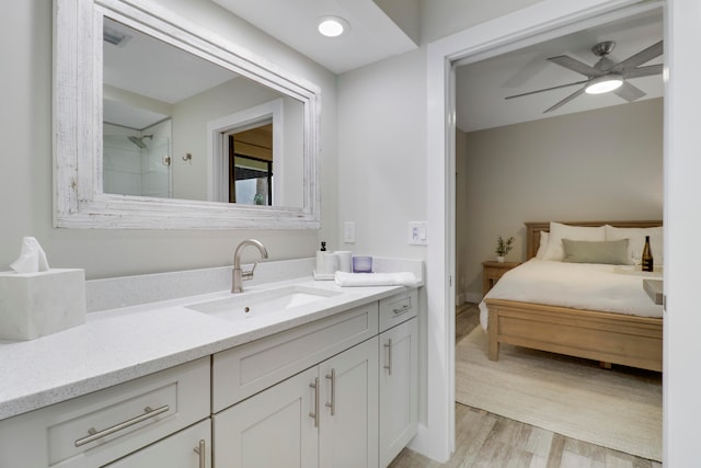 bathroom with vanity, a shower, wood-type flooring, and ceiling fan