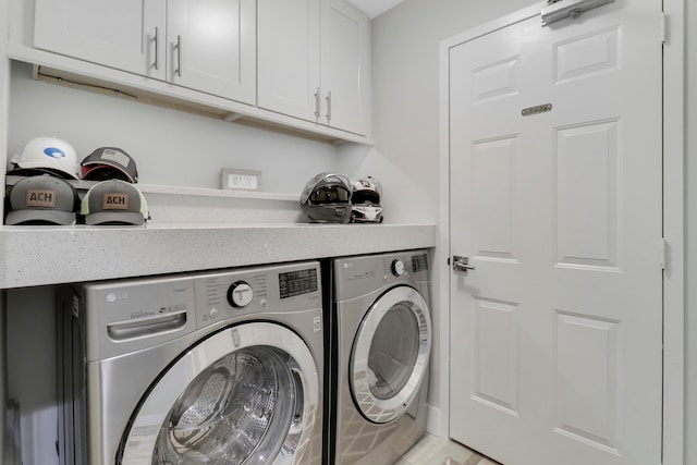 washroom with cabinets, washer and clothes dryer, and light hardwood / wood-style floors