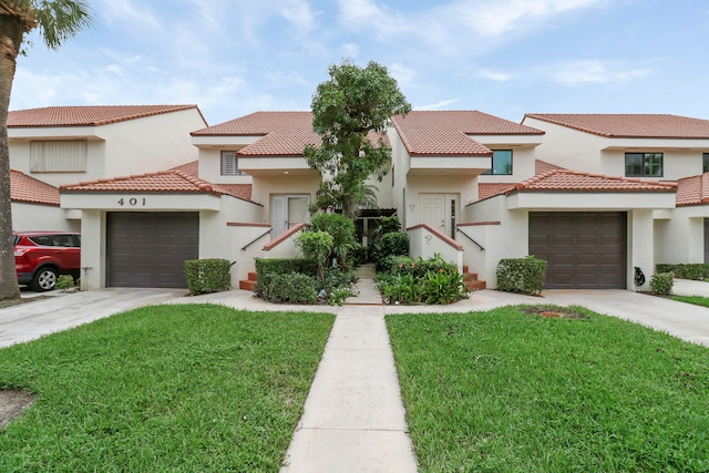 mediterranean / spanish-style house featuring a front lawn and a garage