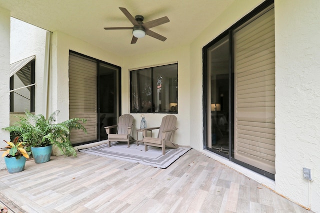 wooden deck featuring ceiling fan