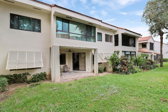 back of property featuring a yard, a patio, and ceiling fan