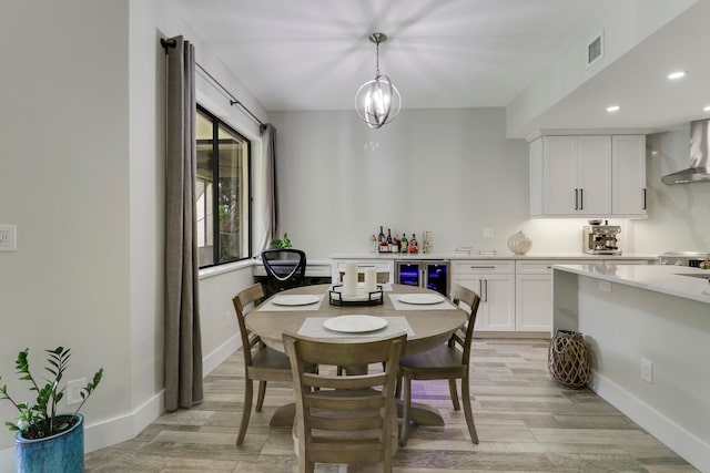 dining room with wine cooler and light hardwood / wood-style floors