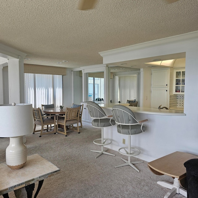 dining room featuring a textured ceiling and carpet floors