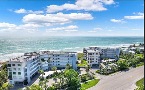 birds eye view of property with a view of the beach and a water view