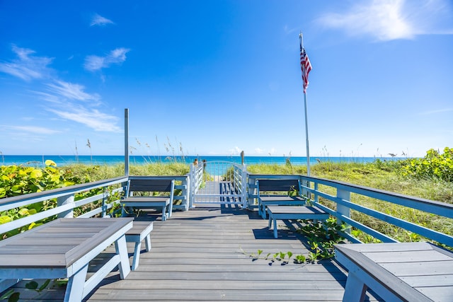 exterior space with a water view and a beach view