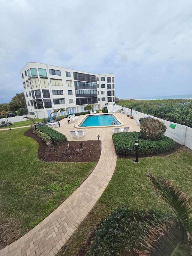 view of pool with a lawn and a patio area