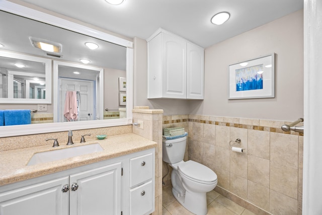 bathroom with vanity, tile walls, toilet, and tile patterned floors