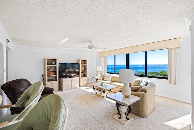 carpeted living room featuring ornamental molding, ceiling fan, and a textured ceiling