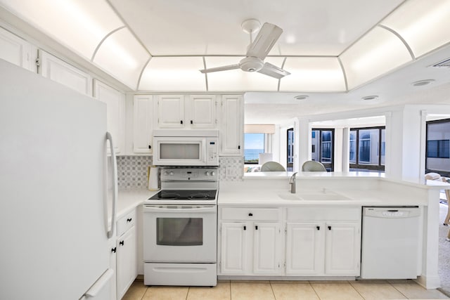 kitchen with white cabinetry, tasteful backsplash, white appliances, light tile patterned floors, and sink