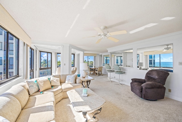 carpeted living room featuring a textured ceiling, a water view, and ceiling fan