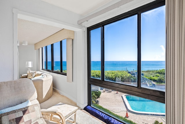 bedroom with a water view, a textured ceiling, and carpet flooring