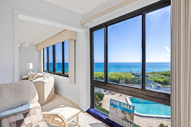 interior space featuring carpet flooring and a water view