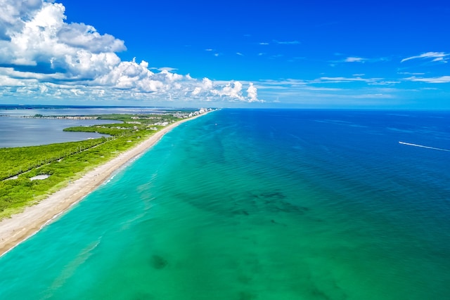 bird's eye view featuring a water view and a beach view