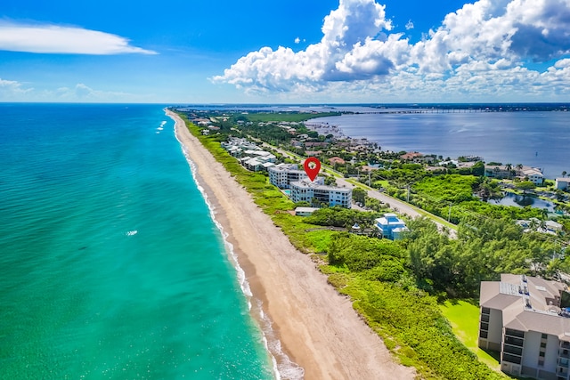 drone / aerial view featuring a water view and a beach view