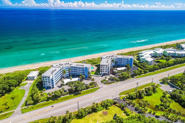 drone / aerial view with a beach view and a water view