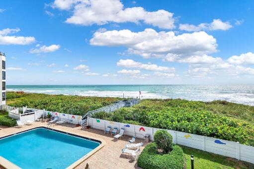 view of swimming pool with a water view