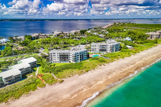 drone / aerial view featuring a view of the beach and a water view